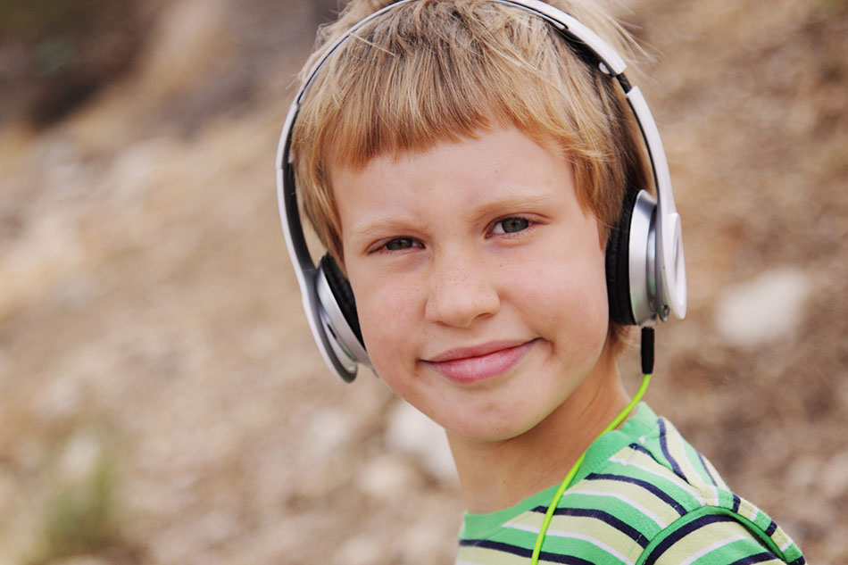 Portrait of cute autistic boy with headphones